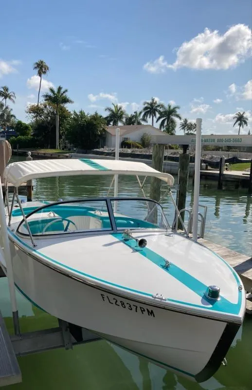 Slide: The Image of 2013 Cherubini 20 VS boat docked on sunny waterfront with palm trees. - 20