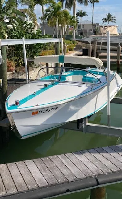 Slide: The Image of Cherubini 20 VS 2013 boat docked, featuring teal accents and a canopy, surrounded by palm trees. - 6