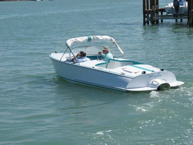 Slide: The Image of 2013 Cherubini 20 VS boat cruising on calm waters with two passengers. - 8
