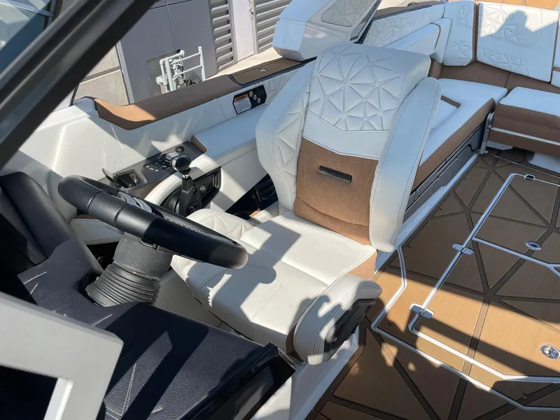 Slide: The Image of 2024 Nautique Super Air Nautique G25 Paragon interior with luxury seating and modern controls. - 10