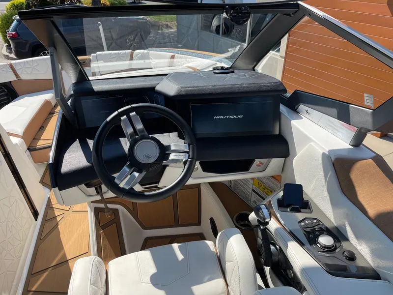 Slide: The Image of 2024 Nautique Super Air Nautique G25 Paragon cockpit with modern steering and controls. - 11