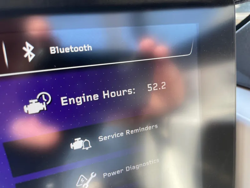 Slide: The Image of 2024 Nautique Super Air G25 Paragon display showing 52.2 engine hours and Bluetooth connectivity. - 12