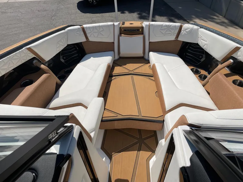 Slide: The Image of 2024 Nautique Super Air Nautique G25 Paragon interior with luxurious seating and wood accents. - 9