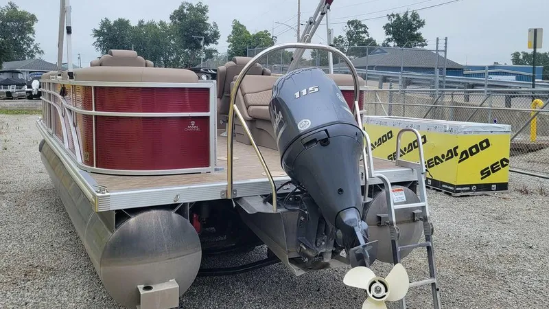 Slide: The Image of 2023 Bennington 22 SSR pontoon boat with outboard motor, parked on gravel. - 10