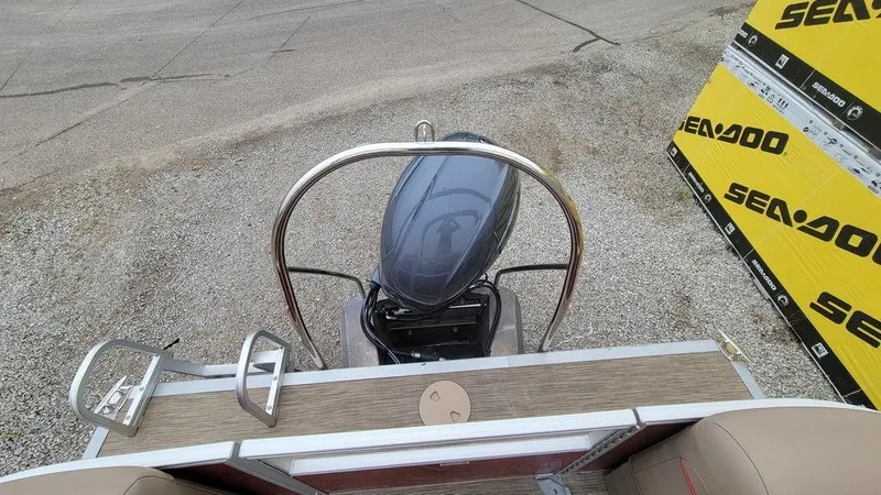 Slide: The Image of 2023 Bennington 22 SSR boat with outboard motor, docked near Sea-Doo signage. - 14