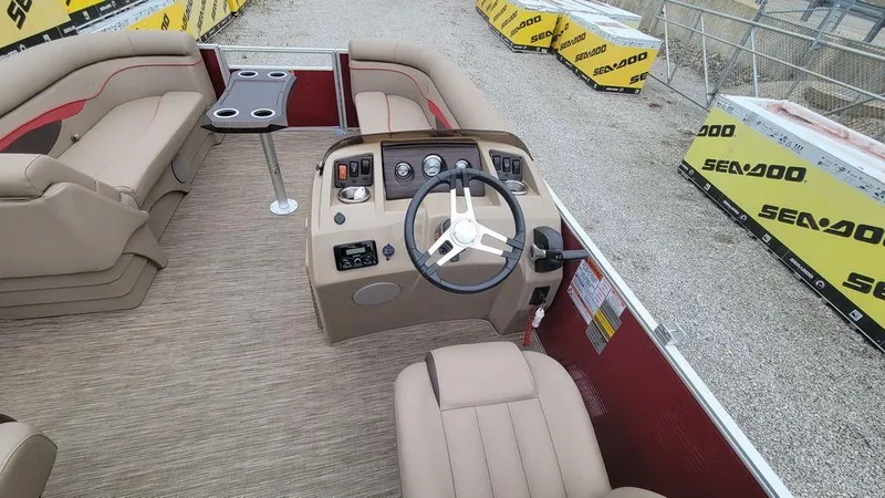 Slide: The Image of 2023 Bennington 22 SSR boat interior with beige seating and steering console. - 3