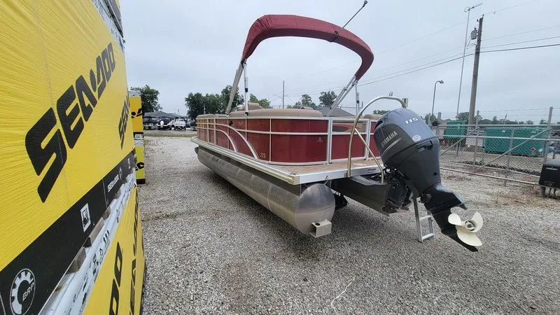 Slide: The Image of 2023 Bennington 22 SSR pontoon boat with red canopy and Yamaha outboard motor. - 4