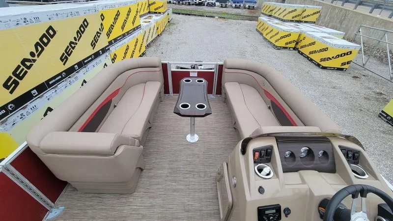 Slide: The Image of 2023 Bennington 22 SSR pontoon boat interior with beige seating and central table. - 5