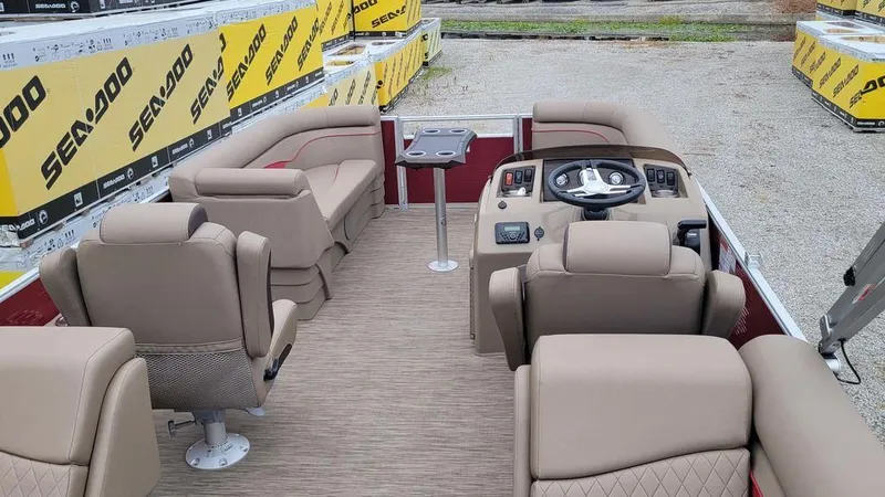 Slide: The Image of 2023 Bennington 22 SSR pontoon boat interior with beige seating and steering console. - 6