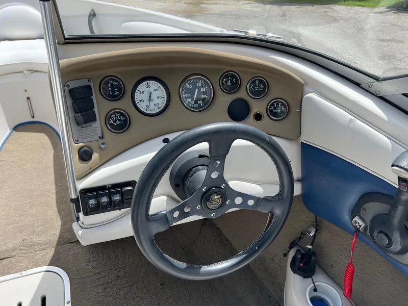 Slide: The Image of 2002 Crownline 180 BR boat dashboard with steering wheel and instrument panel. - 12
