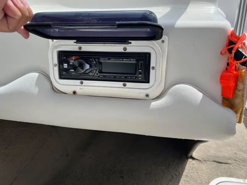 Slide: The Image of 2002 Crownline 180 BR boat stereo system with protective cover open. - 14