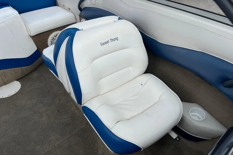 Slide: The Image of 2002 Crownline 180 BR boat interior with blue and white seating. - 15
