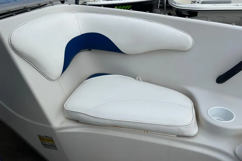 Slide: The Image of 2002 Crownline 180 BR boat seat with white and blue upholstery. - 16