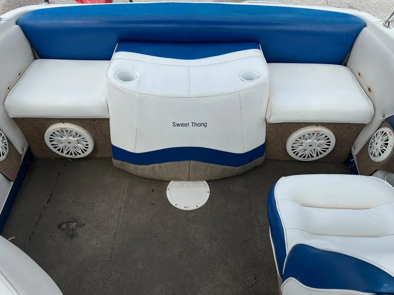Slide: The Image of 2002 Crownline 180 BR boat interior with blue and white seating and cup holders. - 5