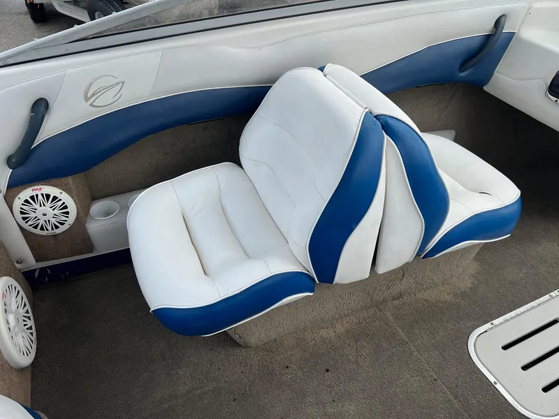 Slide: The Image of 2002 Crownline 180 BR boat interior with white and blue seating. - 7