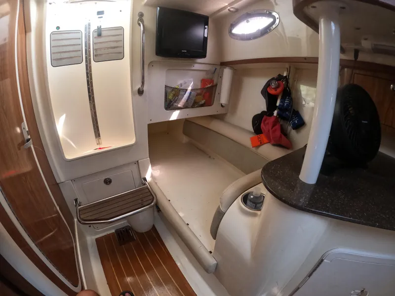 Slide: The Image of 2010 Scout 262 Abaco cabin interior with seating, TV, and storage. - 15