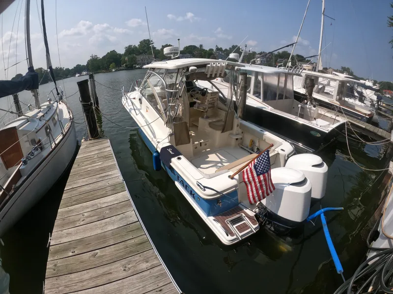 Slide: The Image of 2010 Scout 262 Abaco boat docked with American flag, sunny day. - 4