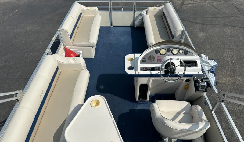 Slide: The Image of 1998 Crest II pontoon boat interior with seating and steering console. - 12