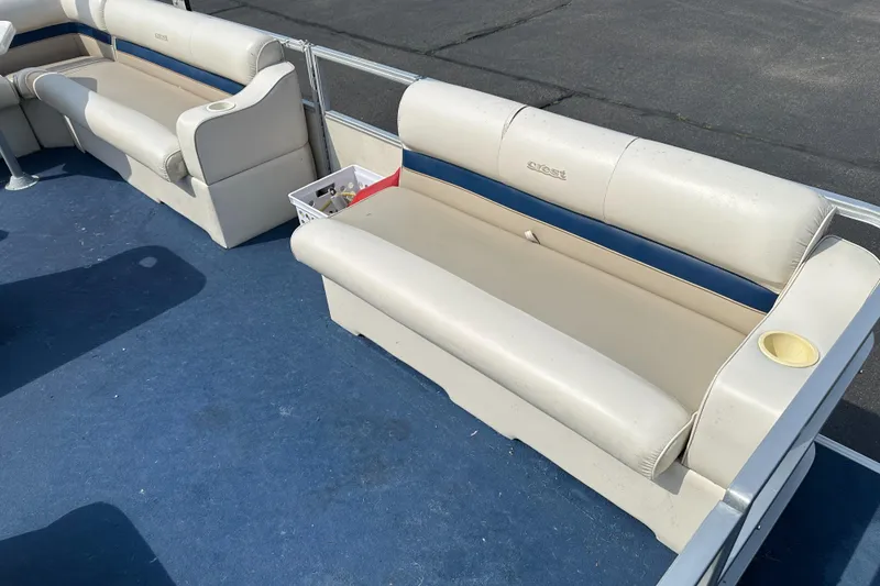 Slide: The Image of 1998 Crest II boat interior with beige seating and blue carpet. - 6