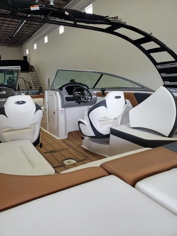 Slide: The Image of 2024 Chaparral 23 SSi OB boat interior with modern seating and sleek design. - 3