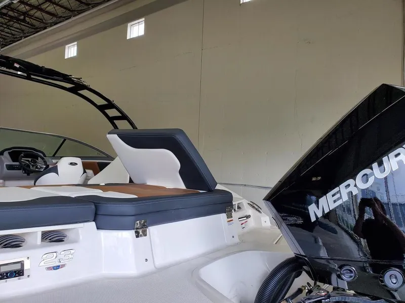 Slide: The Image of 2024 Chaparral 23 SSi OB boat with Mercury outboard engine in a warehouse. - 6