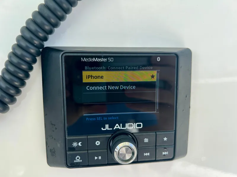 Slide: The Image of JL Audio MediaMaster 50 display on 2023 Cobia 237 CC boat, showing Bluetooth connection options. - 18