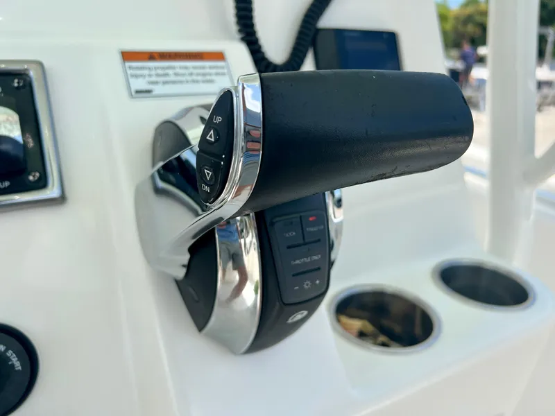 Slide: The Image of Close-up of 2023 Cobia 237 CC boat throttle control. - 23
