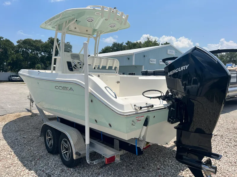 Slide: The Image of 2023 Cobia 237 CC boat with Mercury engine on a trailer. - 5