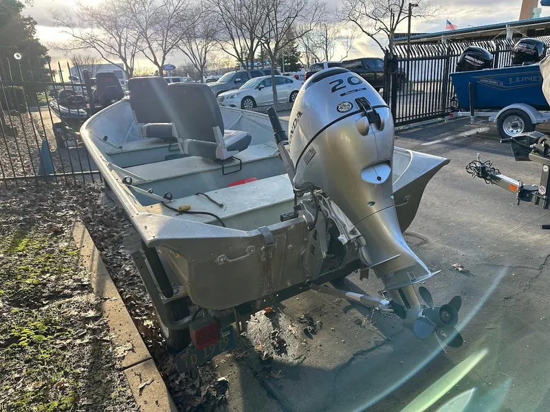 Slide: The Image of 1983 Valco 12 boat with Honda outboard motor in a parking lot. - 4