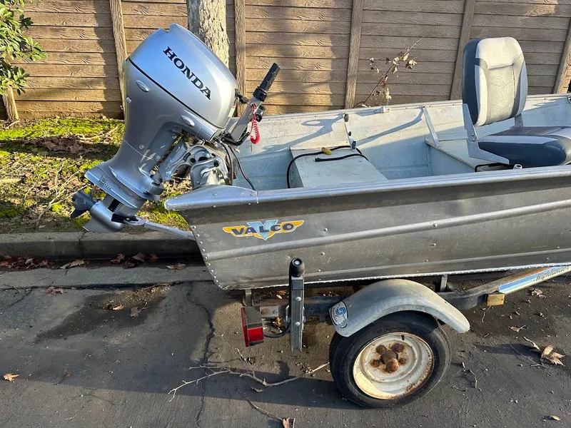 Slide: The Image of 1983 Valco 12 boat with Honda outboard motor on a trailer. - 5