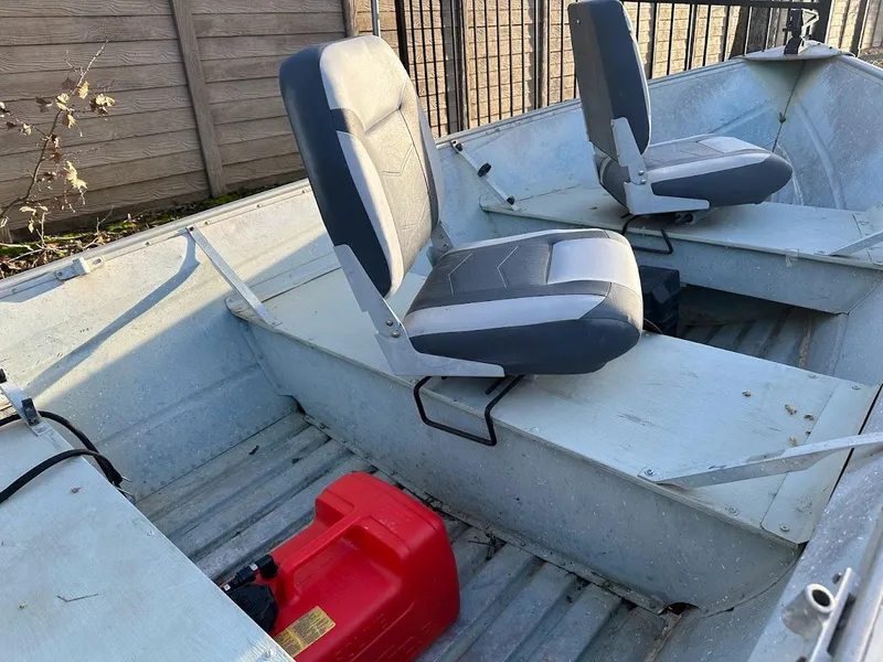 Slide: The Image of 1983 Valco 12 boat interior with two seats and a red fuel tank. - 8