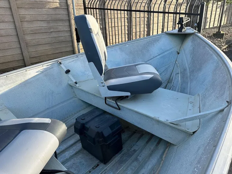 Slide: The Image of 1983 Valco 12 boat interior with seats and storage box. - 9