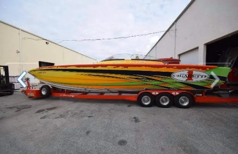 Slide: The Image of 2009 Cigarette 399 Vee speedboat with vibrant graphics on a trailer. - 2