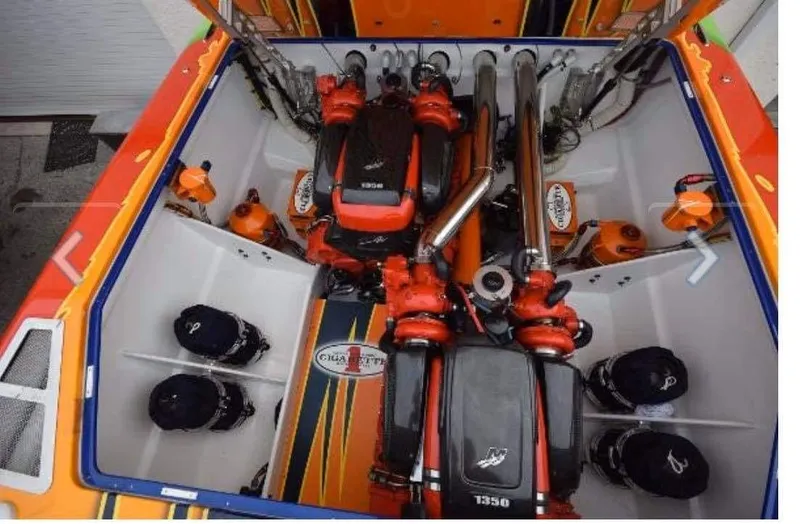Slide: The Image of 2009 Cigarette 399 Vee boat engine compartment with vibrant orange and black design. - 7