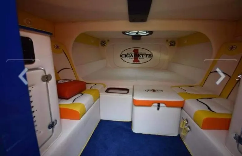 Slide: The Image of Interior of 2009 Cigarette 399 Vee boat with cushioned seating and storage. - 8