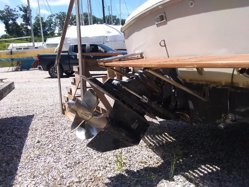 Slide: The Image of 1987 Hinterhoeller Limestone Express boat propeller and stern, parked on gravel. - 11