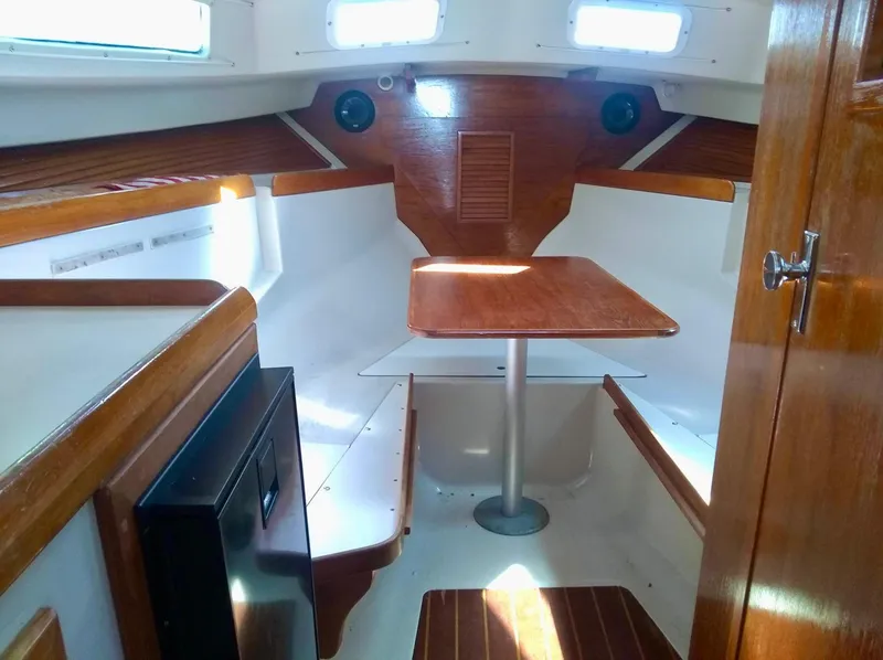 Slide: The Image of 1987 Hinterhoeller Limestone Express cabin interior with wood finish and seating area. - 12