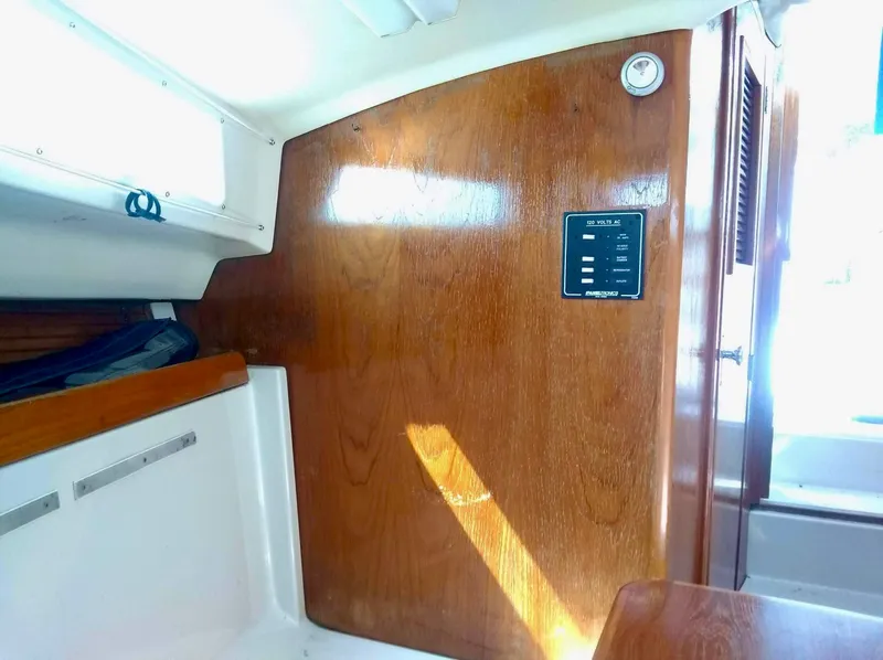 Slide: The Image of 1987 Hinterhoeller Limestone Express cabin interior with wood paneling and control panel. - 15