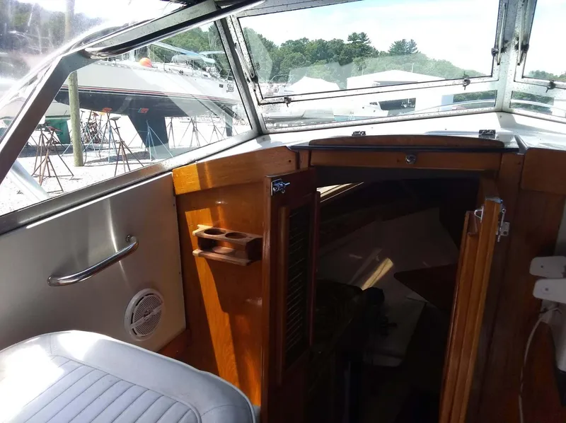 Slide: The Image of 1987 Hinterhoeller Limestone Express boat interior with wooden cabinetry and seating. - 8