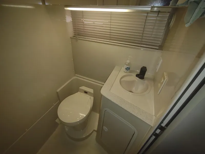Slide: The Image of 1998 Cruisers Yachts 3870 Esprit bathroom with toilet, sink, and blinds. - 31