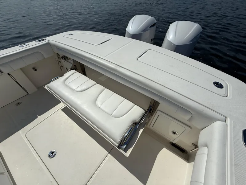 Slide: The Image of 2018 Regulator 31 boat with dual engines and white seating on calm water. - 12