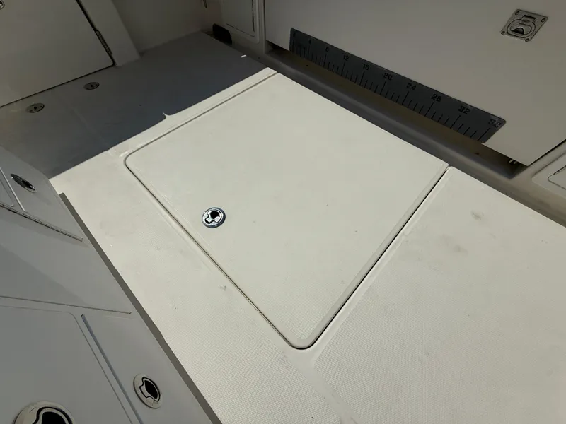 Slide: The Image of 2018 Regulator 31 boat deck with storage hatch and measurement ruler. - 15