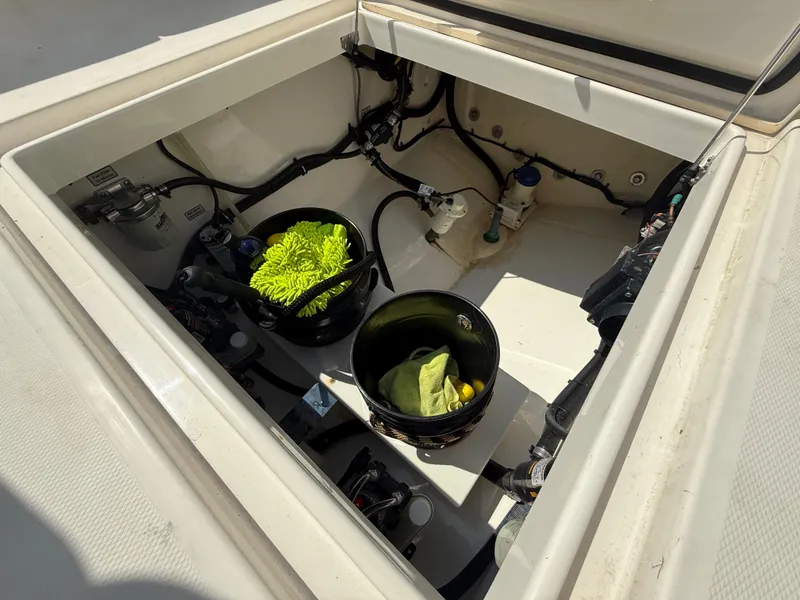 Slide: The Image of Open storage compartment of a 2018 Regulator 31 boat with cleaning supplies. - 16