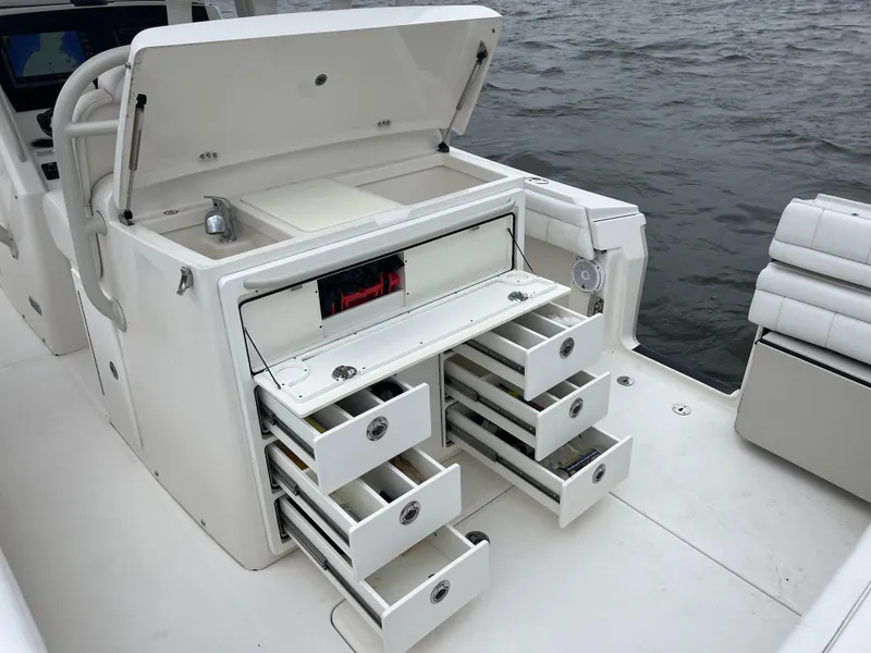 Slide: The Image of 2018 Regulator 31 boat with open storage drawers and compartments on deck. - 19