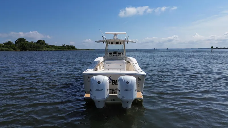 Slide: The Image of 2018 Regulator 31 boat with dual Yamaha engines on calm water. - 2