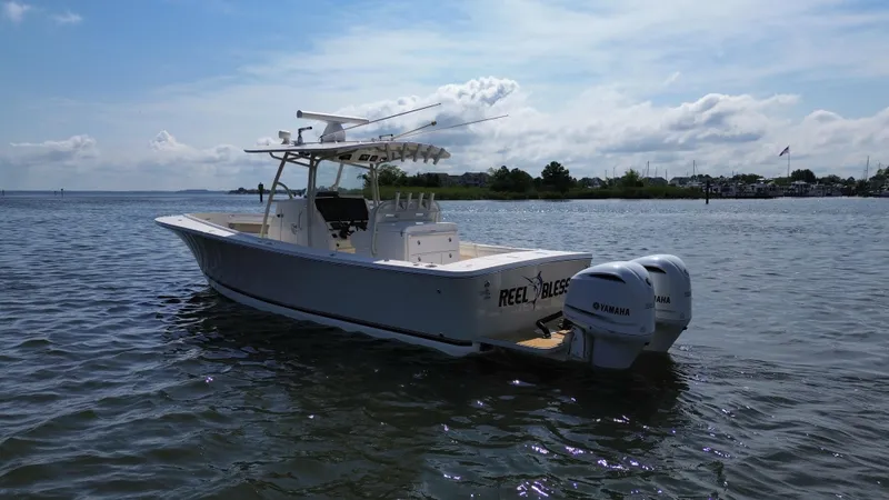 Slide: The Image of 2018 Regulator 31 boat with twin Yamaha engines on calm water. - 3