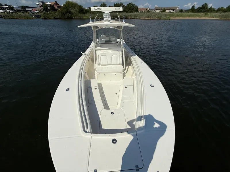 Slide: The Image of 2018 Regulator 31 boat on calm water, featuring spacious deck and Garmin equipment. - 31