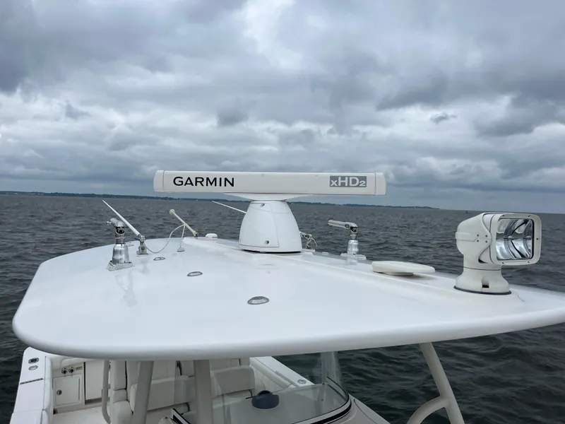 Slide: The Image of 2018 Regulator 31 boat with Garmin xHD2 radar on open water under cloudy skies. - 32