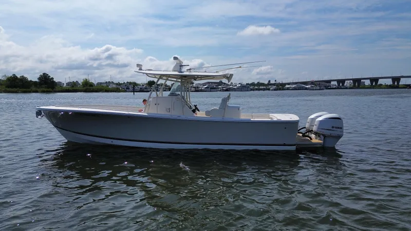 Slide: The Image of 2018 Regulator 31 boat on calm water with Yamaha engines, under a partly cloudy sky. - 4