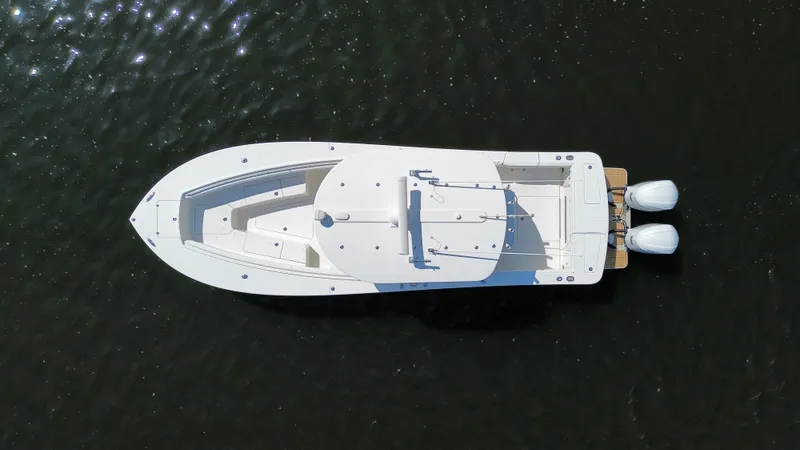 Slide: The Image of Aerial view of 2018 Regulator 31 boat on water with twin engines. - 6